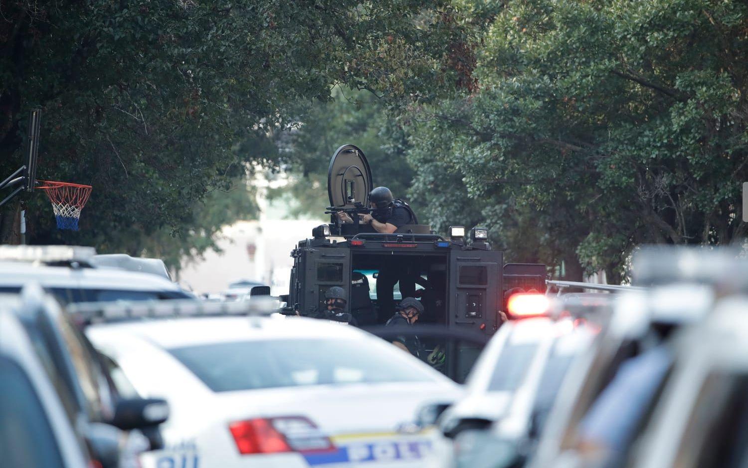 Authorities stand outside a house as they investigate an active shooting situation, Wednesday, Aug. 14, 2019, in the Nicetown neighborhood of Philadelphia. (AP Photo/Matt Rourke)